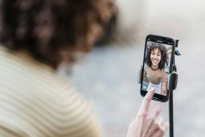 The girl takes a video on her phone